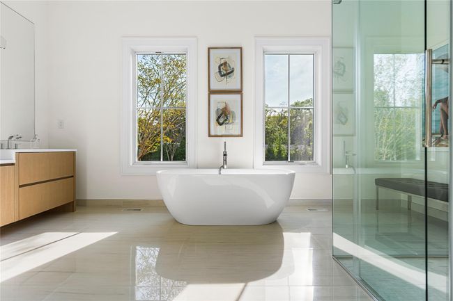 Full bathroom featuring tile patterned floors, vanity, and a freestanding tub | Image 30