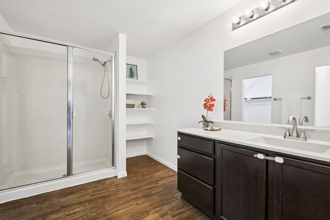 Bathroom with a stall shower, wood finished floors, and double vanity | Image 20