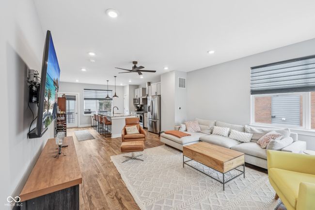 living room with baseboards, light wood-type flooring, ceiling fan, and recessed lighting | Image 5