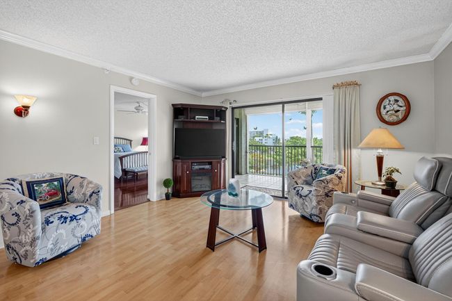 Bright & Beautiful Living Room with Great Views of the Pool & Lake & Garden | Image 14