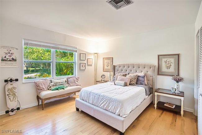 Bedroom with light wood-style floors and baseboards | Image 24