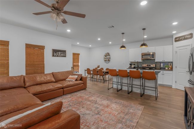 Living area featuring recessed lighting, light wood finished floors, visible vents, and a ceiling fan | Image 5