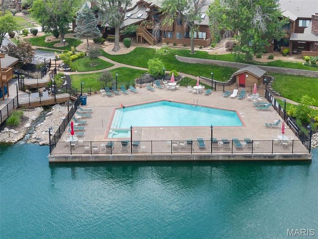 Community pool featuring a water view | Image 29
