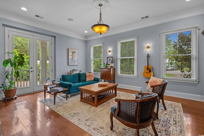 Living area with healthy amount of natural light, wood-type flooring, ornamental molding, french doors, and recessed lighting | Image 10