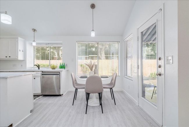 Dining space featuring light wood finished floors, lofted ceiling, and baseboards | Image 12
