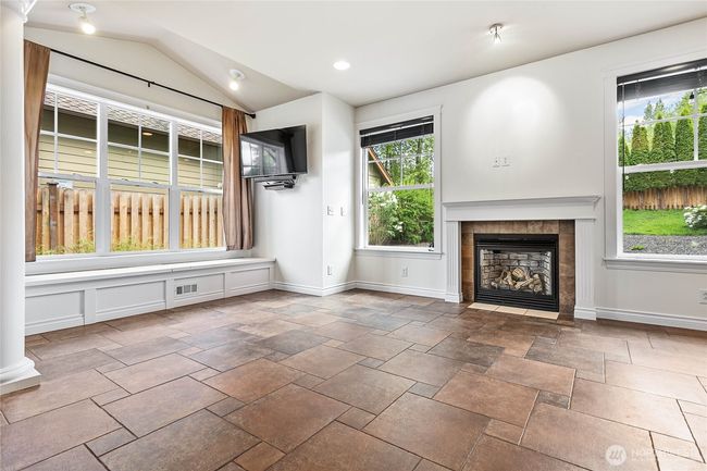 Orient your living room around the cozy gas fireplace. There's extra storage under the huge picture window benches. | Image 12