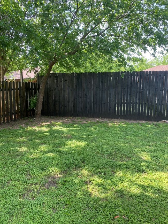 View of yard with a fenced backyard | Image 17