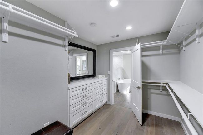 Spacious closet featuring light wood-type flooring | Image 13