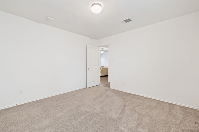 Spare room featuring light carpet and baseboards | Image 30