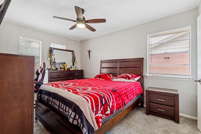 Bedroom with carpet flooring, ceiling fan, crown molding, and baseboards | Image 18