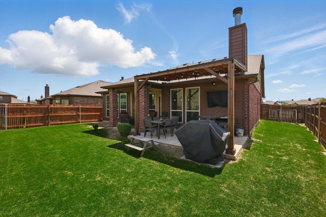 Back of house with a patio, a chimney, a fenced backyard, and a lawn | Image 34