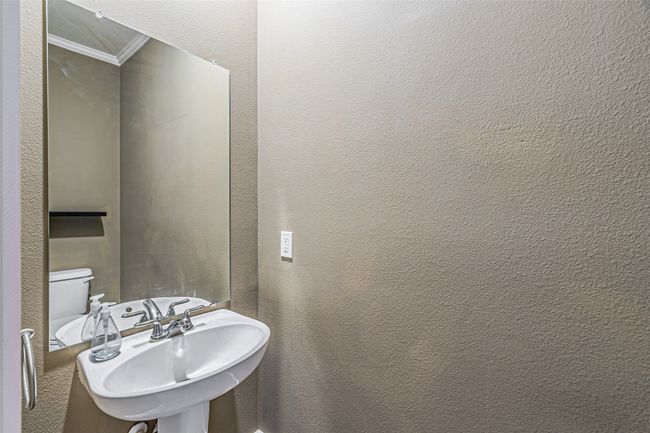 Half bath with crown molding and a textured wall | Image 8