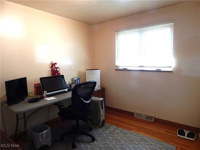 Bedroom 1 is being used as an Office with hardwood finished floors & nice sized closet. | Image 16