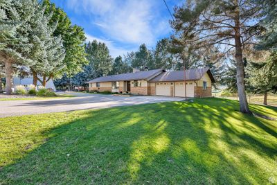 Ranch-style home featuring a garage and a front lawn | Image 3