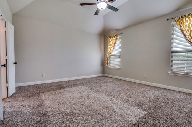 Unfurnished room featuring lofted ceiling, carpet, and ceiling fan | Image 13
