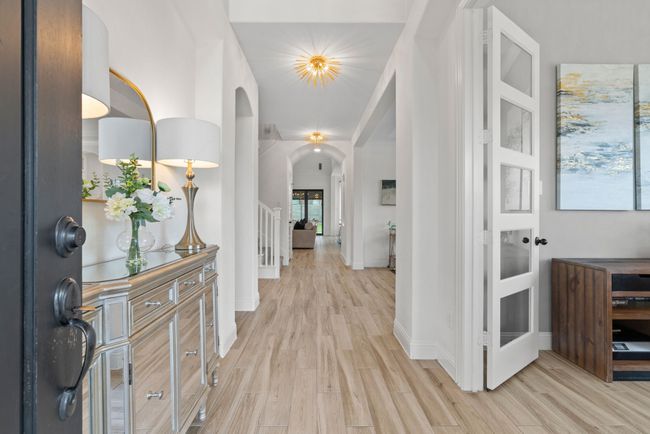 Foyer entrance with light wood-style flooring, arched walkways, and baseboards | Image 6