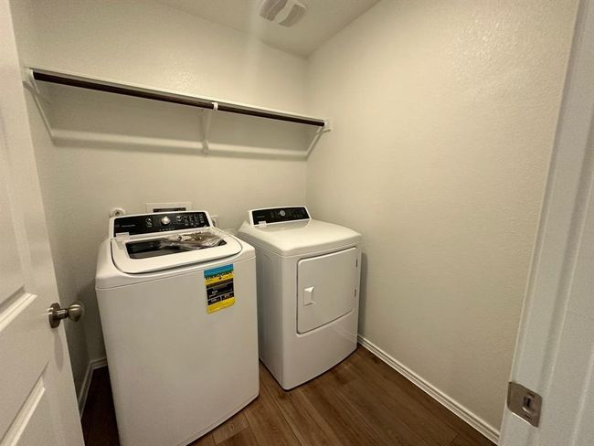 Laundry room featuring independent washer and dryer and dark wood-style floors | Image 33