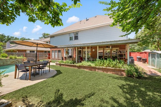 Rear view of property with a yard, a patio, and ceiling fan | Image 13