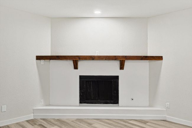 Interior details featuring a fireplace, wood finished floors, and baseboards | Image 21
