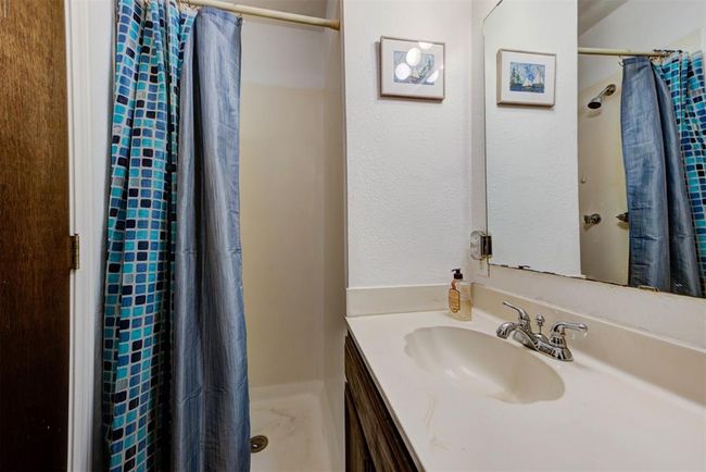 Bathroom with vanity and a shower with shower curtain | Image 12