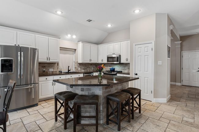 Open kitchen with stainless steel appliances, and view of pool | Image 12