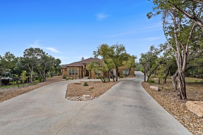 View of front of house with a chimney and curved driveway | Image 4