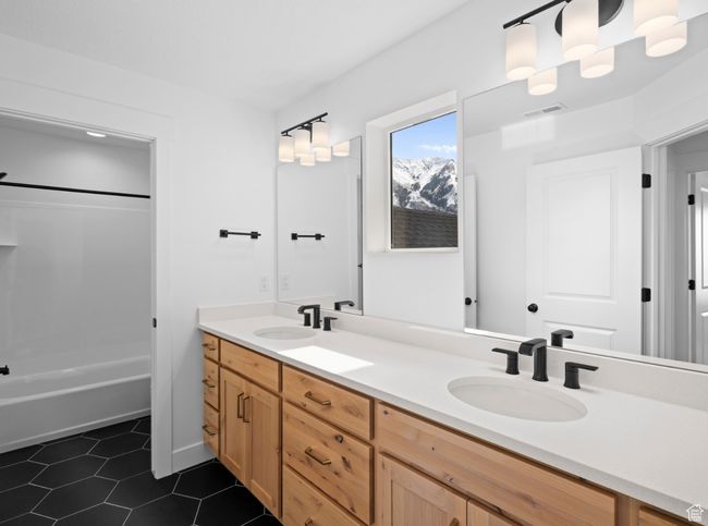 Primary Bathroom with double vanity, a sink, tile patterned floors, and bathtub and large shower | Image 11