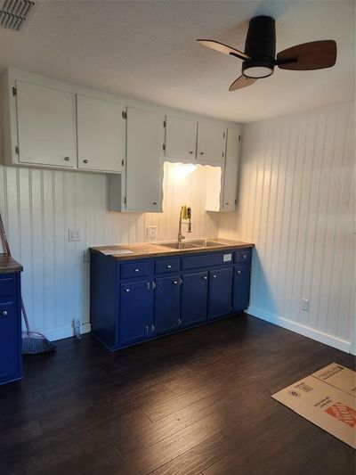 Kitchen featuring white cabinetry, sink, blue cabinetry, and dark hardwood / wood-style flooring | Image 3