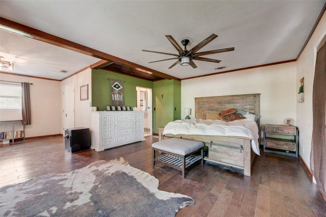 Bedroom with baseboards, ornamental molding, visible vents, and hardwood / wood-style flooring | Image 15