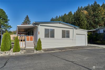 Front of home with covered porch and garage. | Image 1