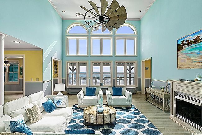 Living room with ornamental molding, a fireplace, and wood finished floors | Image 10