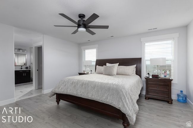 Bedroom featuring visible vents, a ceiling fan, light wood-type flooring, and baseboards | Image 31