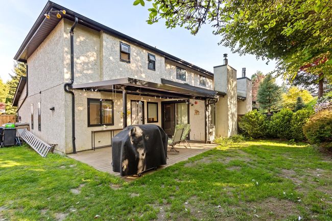 Rear view of home featuring a large covered patio, and a private yard. | Image 30