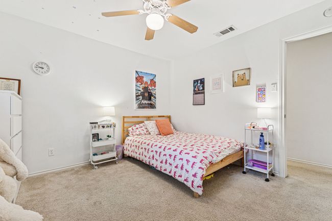 Carpeted bedroom featuring a ceiling fan and baseboards | Image 16