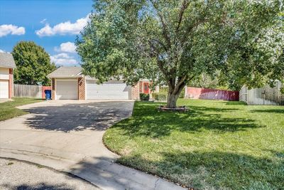 View of front of property with a front yard and a garage | Image 2