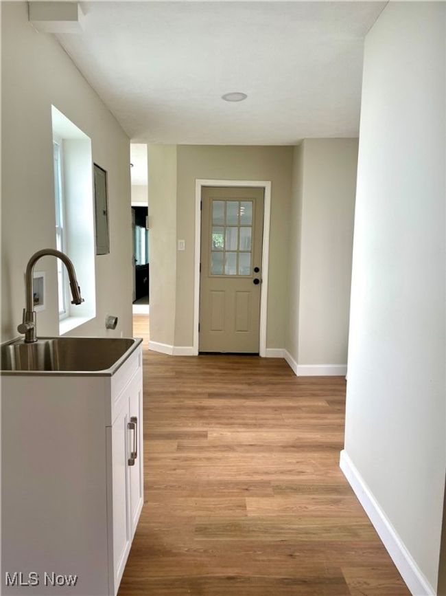 Entryway featuring light wood finished floors and electric panel | Image 9