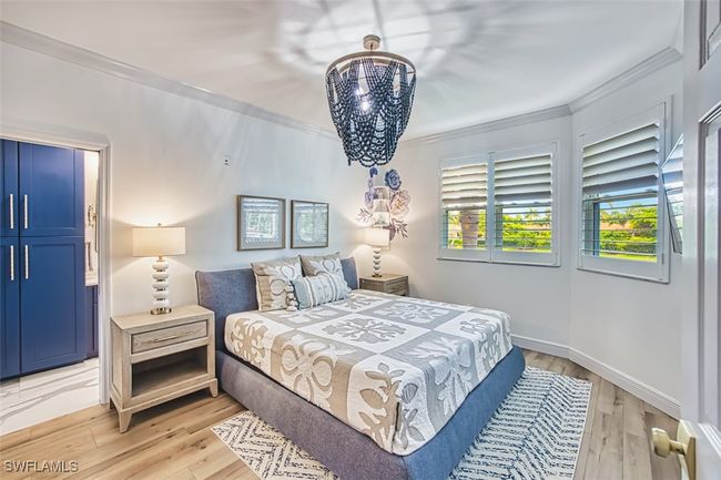 Bedroom featuring crown molding and light wood-type flooring | Image 26