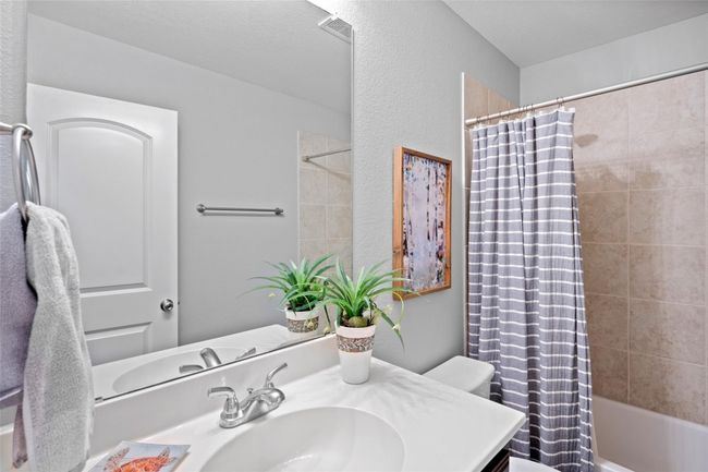 Bathroom with vanity, shower / bathtub combination with curtain, and toilet | Image 12