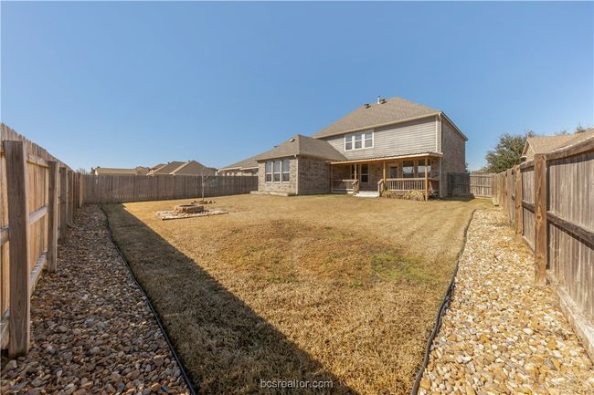 Back of property with an outdoor fire pit and a yard | Image 31