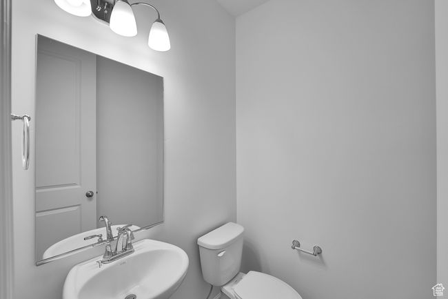 Half bathroom featuring a sink and toilet | Image 27
