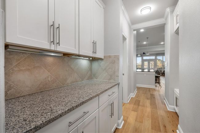 The butler's pantry connects the formal dining room to the kitchen and has plenty of cabinetry to store your serving dishes, chafing dishes and anything you need to throw the perfect party. | Image 34