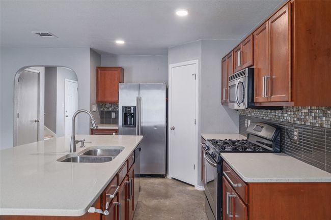 Kitchen with quartz countertops and a huge island | Image 8