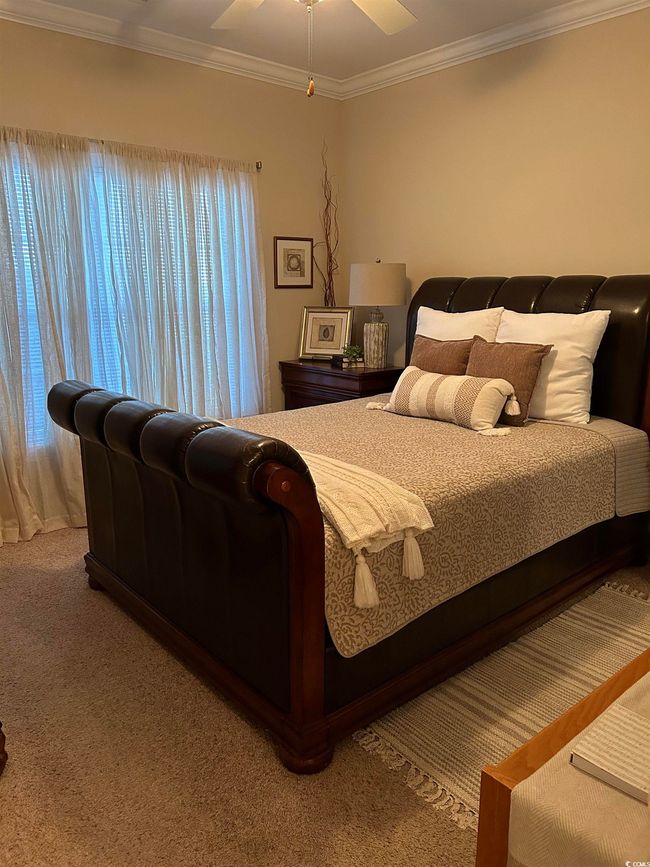 Bedroom with carpet floors and crown molding | Image 15