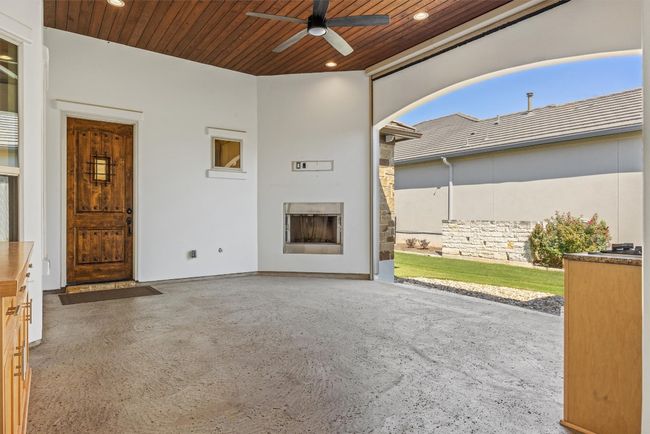 Unique covered patio between the main house and casita with fireplace and remote-controlled shade for the perfect family entertainment and dining area | Image 9