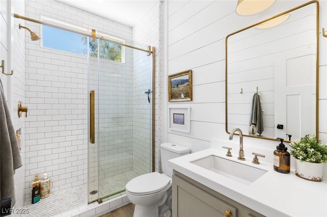 Full bath featuring toilet, vanity, and a stall shower | Image 10
