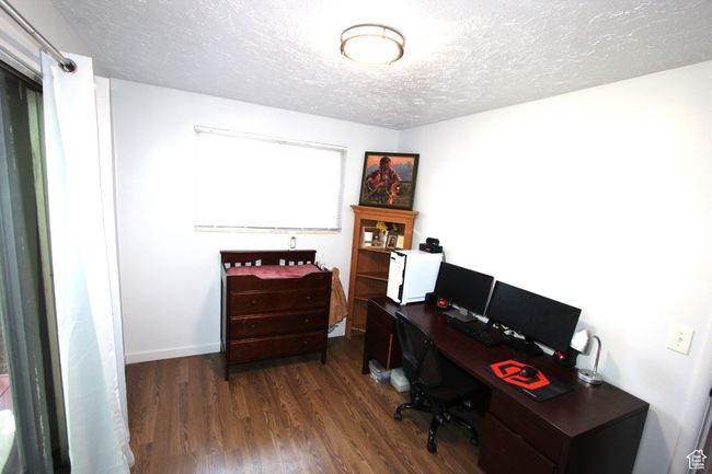 Office area featuring a textured ceiling and dark wood-style flooring | Image 16