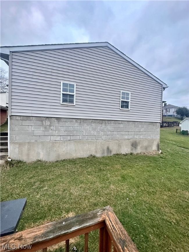 View of property exterior with a lawn | Image 5