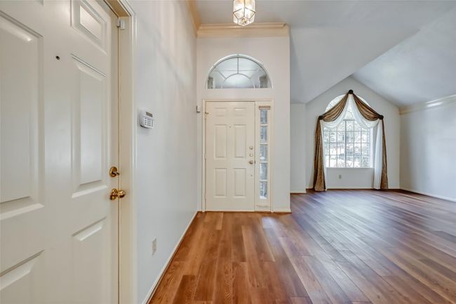 Garage entry connected to llving room. | Image 5