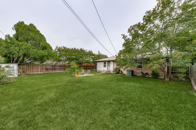 View of fenced backyard | Image 21