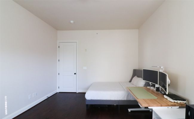 Bedroom featuring dark wood-style floors and baseboards | Image 22